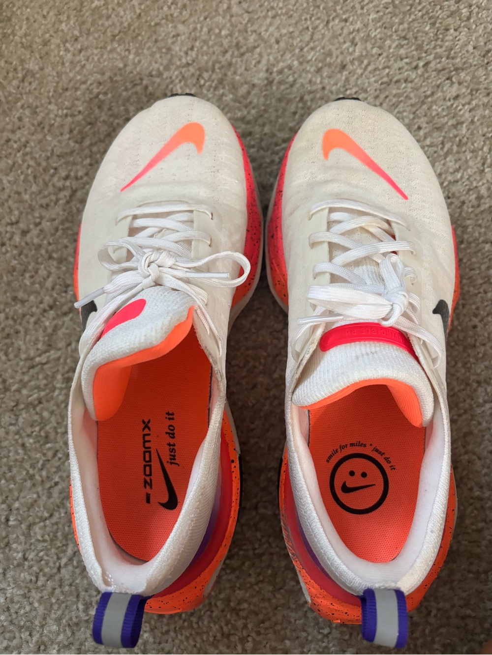 Nike White Running Shoes with Neon Orange and Purple Accents